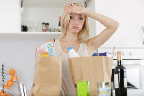 tired young woman holding bags