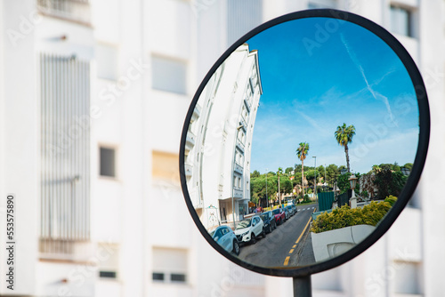 An overview mirror at a crossroads in a country with a warm climate