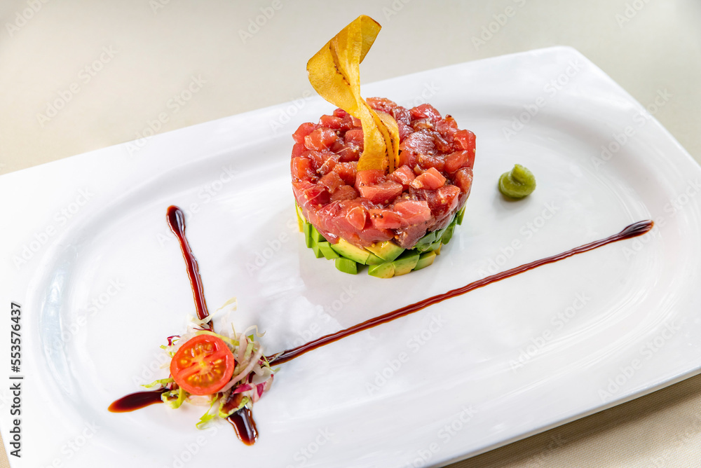 Tuna and avocado tartare on a white plate
