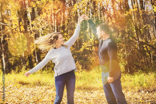 A married couple spending quality time together outdoors in a city park during the fall season; St. Albert, Alberta, Canada