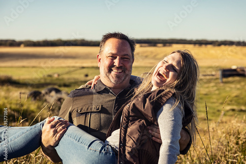 Portrait of a mature couple having fun on their farm; Alcomdale, Alberta, Canada photo