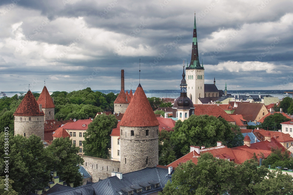 View of old Tallinn from the observation deck. Famous and beautiful view of the old town with watchtowers and Oleviste Church. Summer season in Estonia.