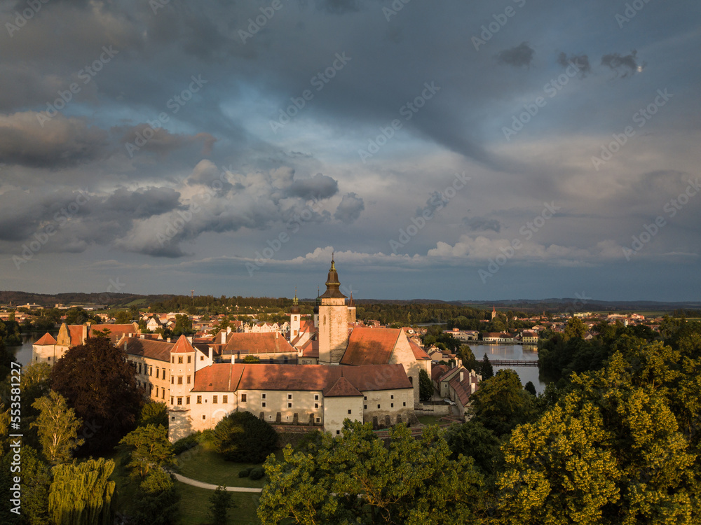 Aerial view just after sunrise of the pond and bridge in front of the Telc castle in the Czech Republic
