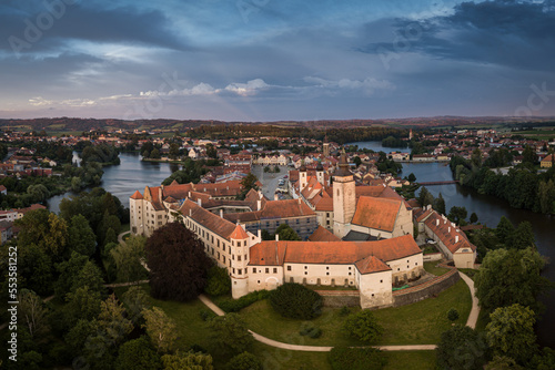 Aerial view just after sunrise of the pond and bridge in front of the Telc castle in the Czech Republic