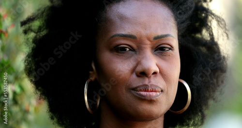 Doubtful African woman frowning being skeptical