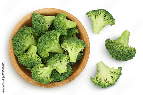 fresh broccoli in wooden bowl isolated on white background close-up with full depth of field. Top view. Flat lay