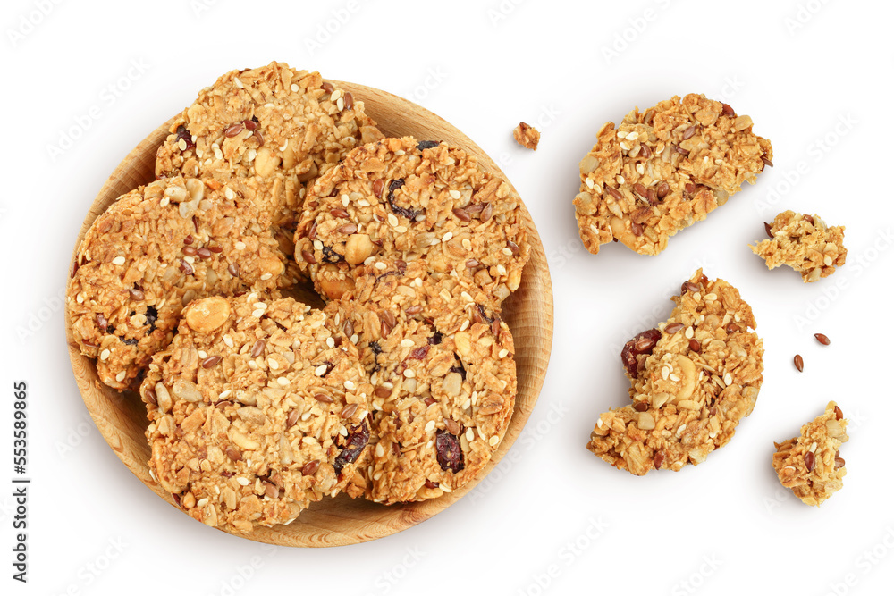 Granola cookie in wooden bowl isolated on white background with full depth of field. Top view. Flat lay. Granola cookie in wooden bowl isolated on white background with full depth of field. Top view. Flat lay.