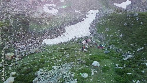 Quadrocopter shoot travelers to high green mountains in the wild nature. The beautiful view from sky with drone  photo