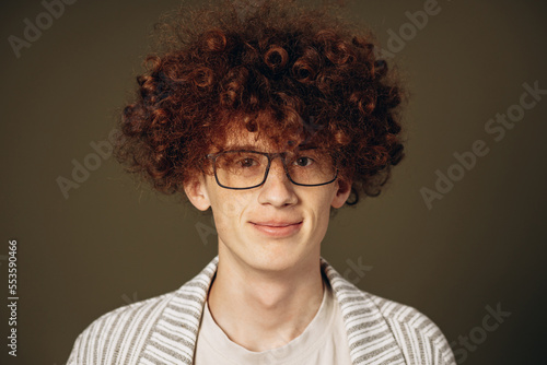 Portrait of young man student with curly red hair