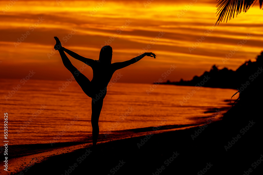 A Nude Latin Model Poses Against The Colorful Sky As The Sun Rises On The Pacific Ocean In Baja California
