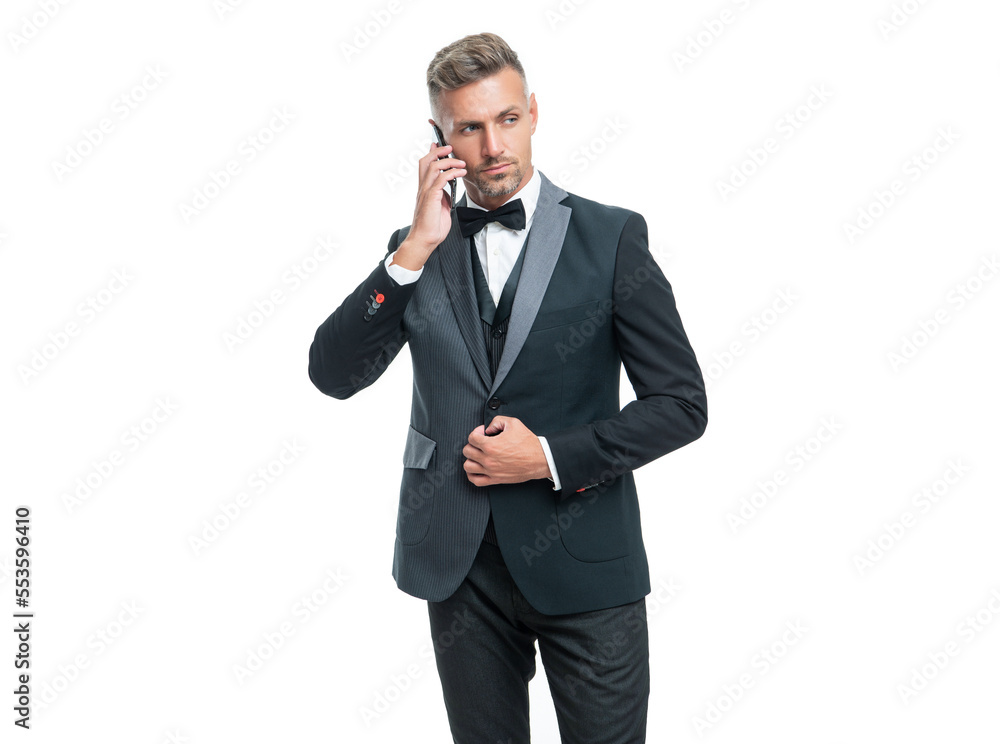 businessman in tux speaking on smartphone isolated on white background businessman in tux speaking on smartphone isolated on white background