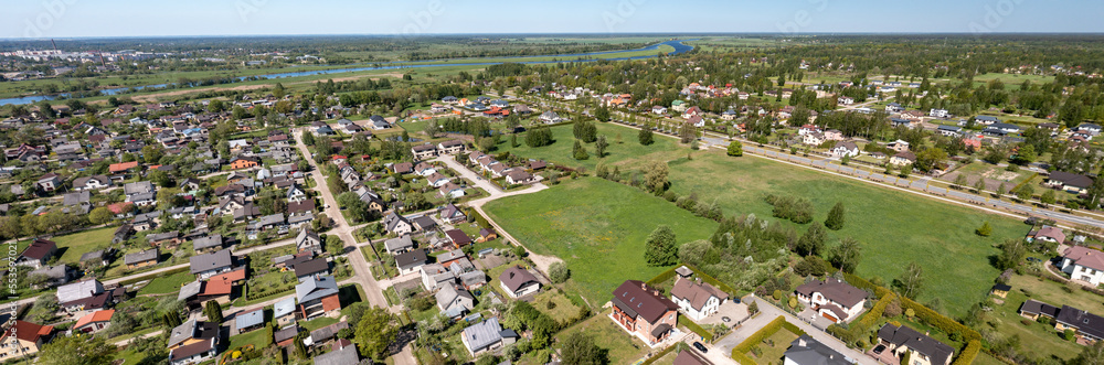 Aerial drone view of cottage village near river at summer. Luxury property.