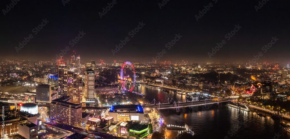 Epic night aerial view of the London, River Thames, London Eye, Westminster. Panorama cityscape