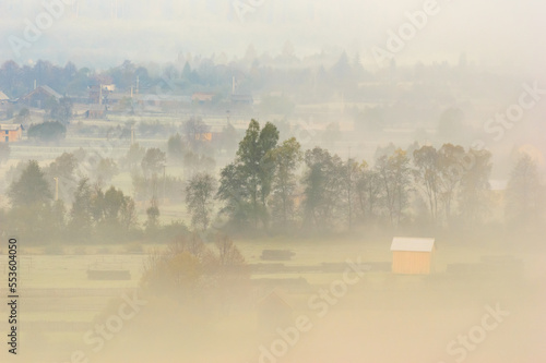 Beautiful scenery landscape Romania village mountains hills fields foggy morning