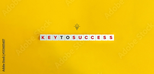 Key to Success Phrase, Banner, Icon, and Concept. Block Letter Tiles on Yellow Background. Minimal Aesthetics. photo