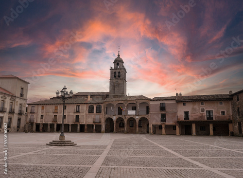 Sunset between red and blue clouds on a summer day from the main square of the medieval town of Medinaceli, located in the province of Soria. Spain photo