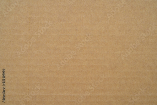 smooth brown cardboard paper, full frame, close up. background and texture of brown paper corrugated sheet board surface