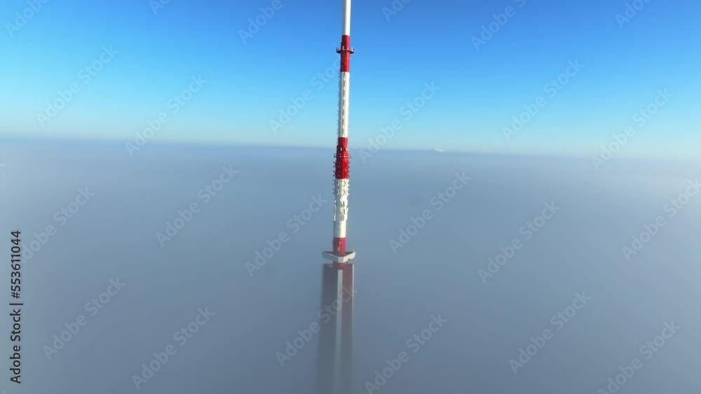 Aerial view of the Riga Radio and TV Tower in Riga, Latvia - the tallest tower in the European Union on a cloudy winter morning. Tower partly covered in thick clouds. Aerial view of the Riga Radio and TV Tower in Riga, Latvia - the tallest tower in the European Union on a cloudy winter morning. Tower partly covered in thick clouds.