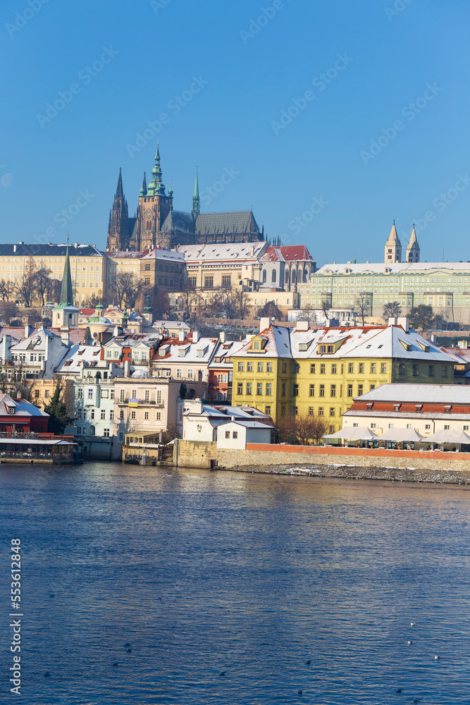 Obraz premium Snowy Prague Lesser Town with Prague Castle above River Vltava in the sunny Day , Czech republic