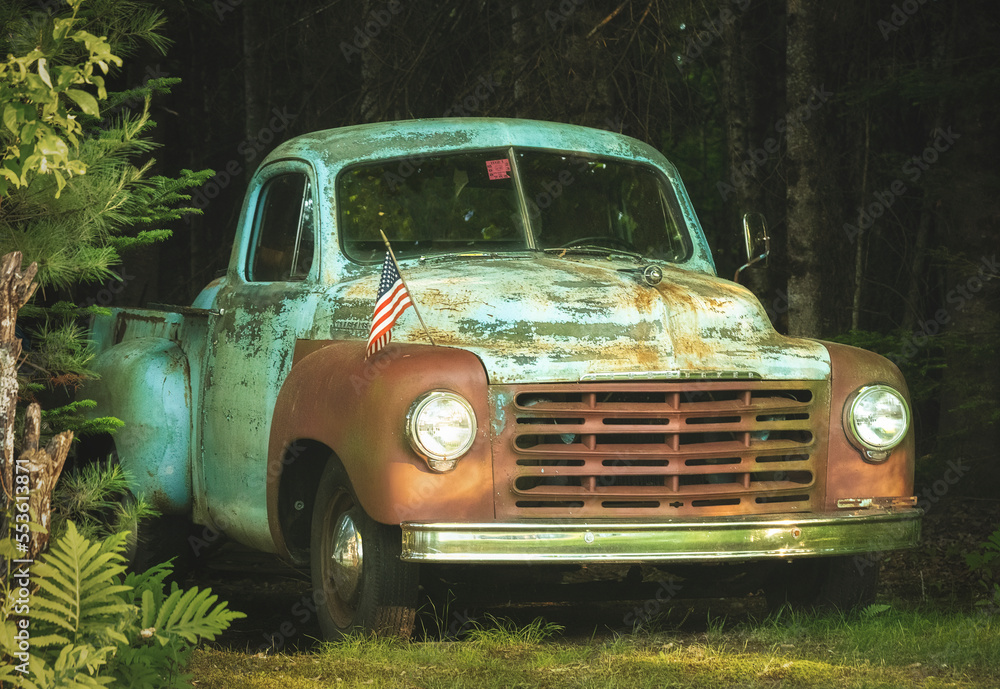 An abandoned truck with an American flag sits abandoned in New Hampshire.