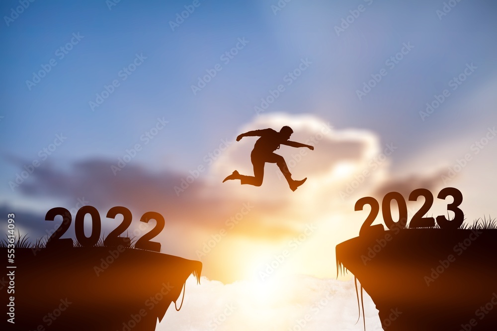 Silhouette of business man jumping on rock Silhouette of business man jumping on rock