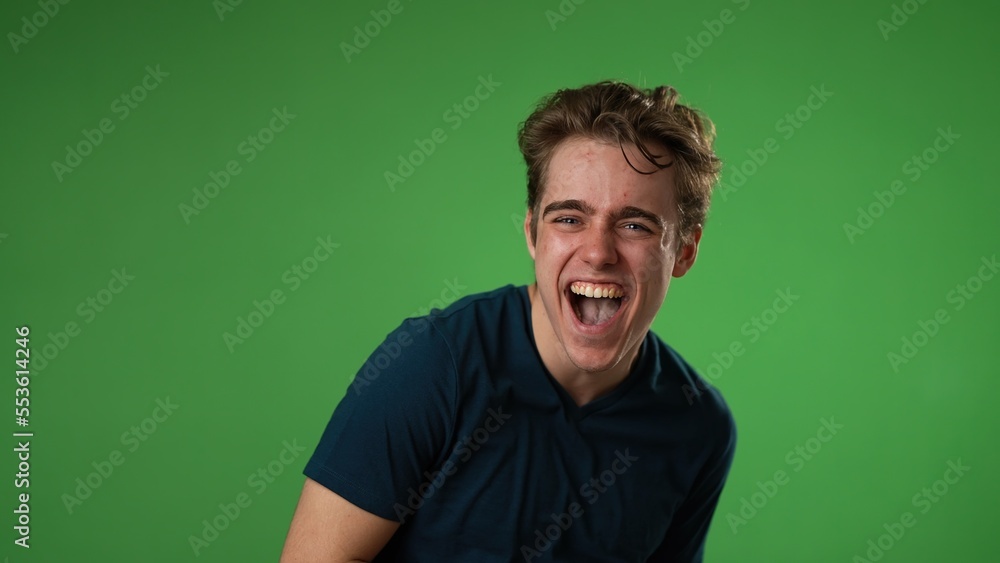 portrait of laughing smiling happy young hipster man 20s isolated on green screen chroma key background with copy space in studio portrait of laughing smiling happy young hipster man 20s isolated on green screen chroma key background with copy space in studio