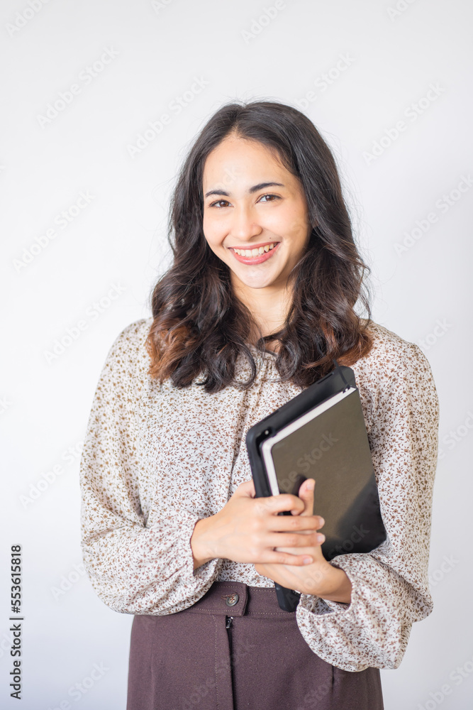 Smiling Asian female student enhancing her future by attending regular lectures Smiling Asian female student enhancing her future by attending regular lectures