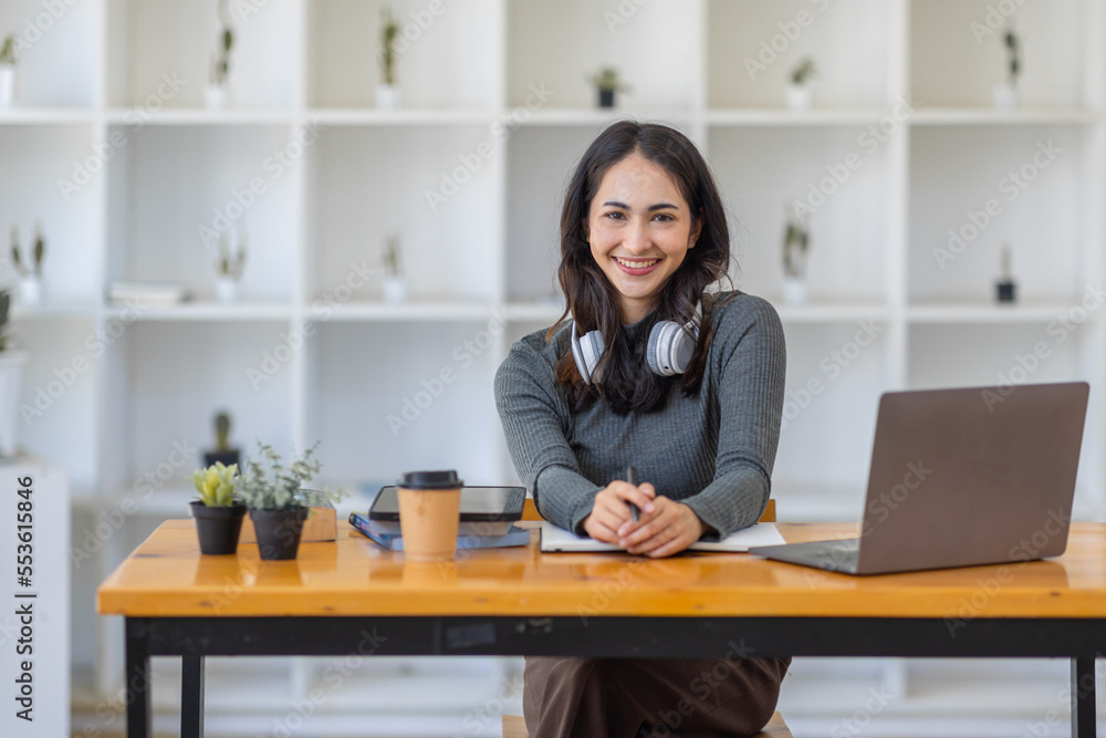 Young adult happy smiling Hispanic Asian student wearing headphones talking on online chat meeting using laptop in university campus or at virtual office. College female student learning remotely.
Young adult happy smiling Hispanic Asian student wearing headphones talking on online chat meeting using laptop in university campus or at virtual office. College female student learning remotely.