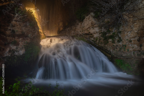 Beautiful waterfall illuminated at night inside the medieval village of Trillo  Guadalajara. Spain