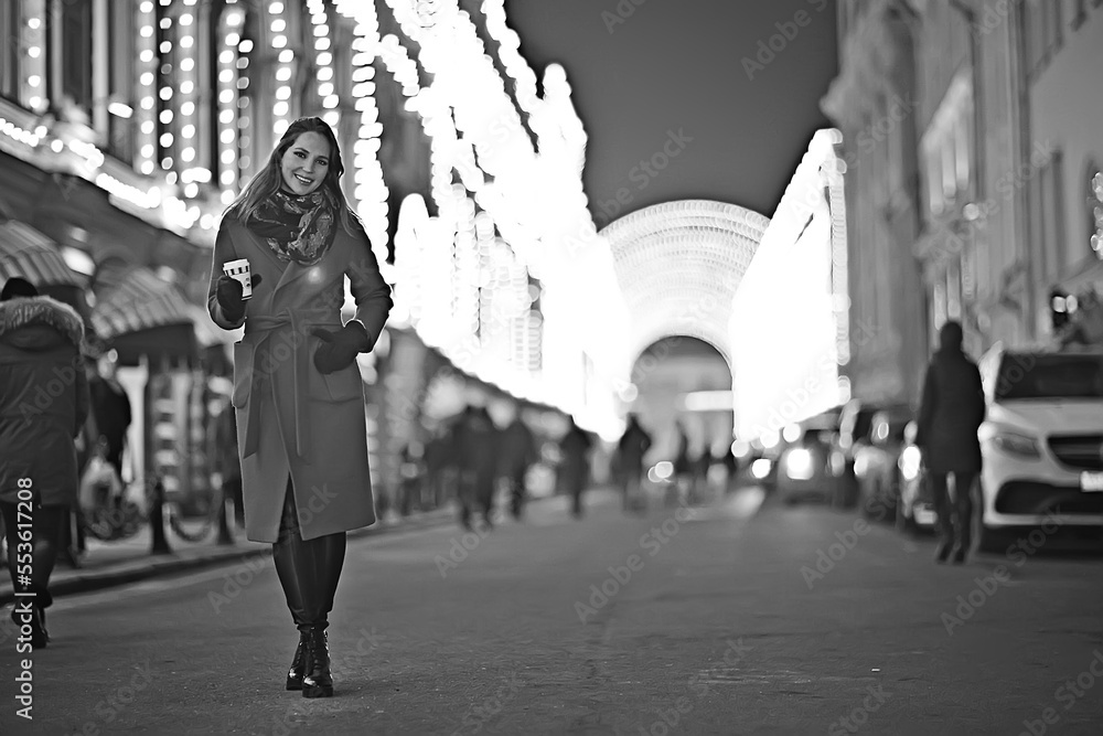 winter night in the city lights / adult girl in a coat walk in the city, fashionable stylish image of a beautiful model winter night in the city lights / adult girl in a coat walk in the city, fashionable stylish image of a beautiful model