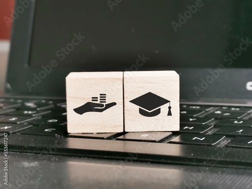 Free Application for Federal Student Aid concept with wooden cubes on laptop.