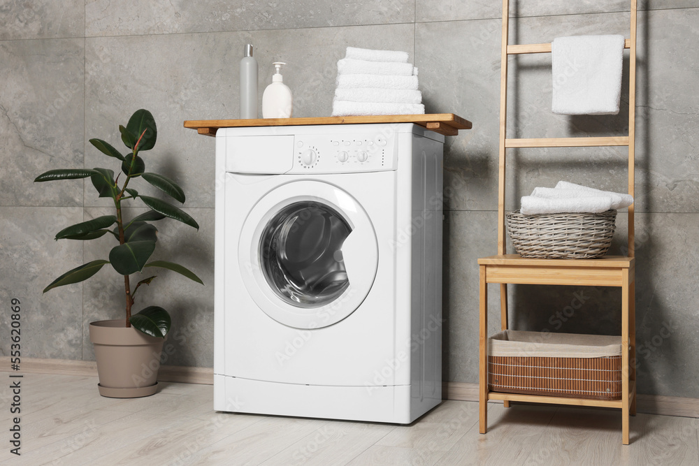 Stylish laundry room with modern washing machine. Interior design