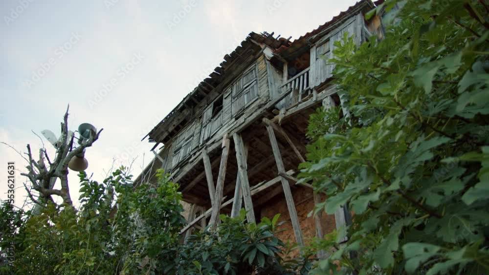 Old wooden abandoned building on elevated site on mountain. house is propped up by wooden sticks that are about to rot. Scary old building where ghosts live and poltergeist happens. Old wooden abandoned building on elevated site on mountain. house is propped up by wooden sticks that are about to rot. Scary old building where ghosts live and poltergeist happens.