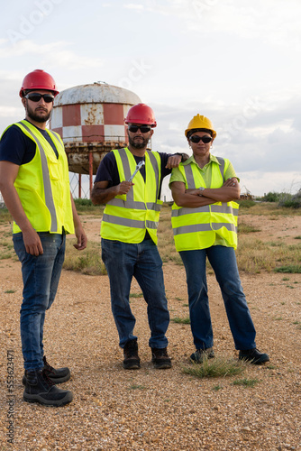 Latino industrial workers standing in the open air