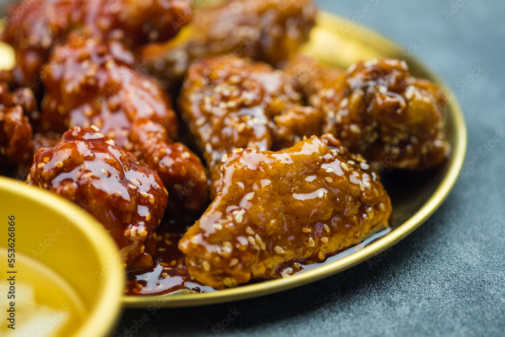 Tasty homemade Korean style deep fried chicken on golden dish Tasty homemade Korean style deep fried chicken on golden dish