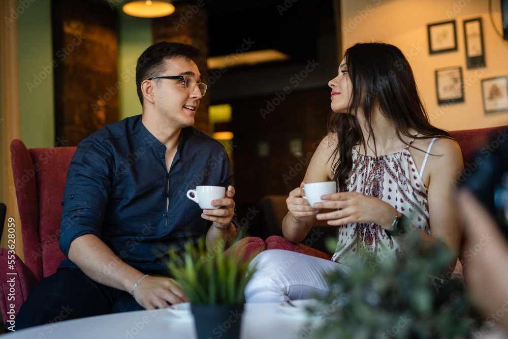 young man and woman happy couple having cup of coffee at home or cafe young man and woman happy couple having cup of coffee at home or cafe