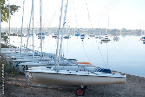 Fotografija Lake Bde Maka Ska (was Lake Calhoun) quiet and calm with sailboats moored on the shoreline and anchored in the water