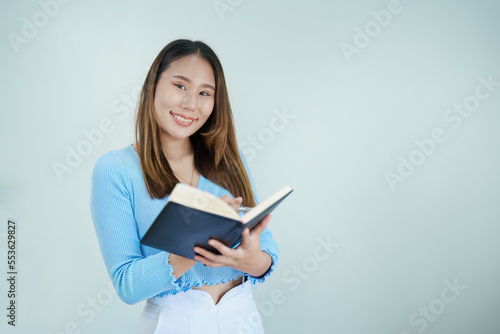 Asian woman reading book relaxing at home