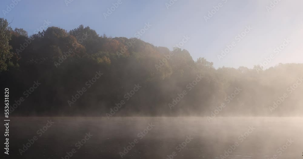 A little fog on the river in the autumn season, fog on the surface of the river in the autumn season during the sunny dawn A little fog on the river in the autumn season, fog on the surface of the river in the autumn season during the sunny dawn