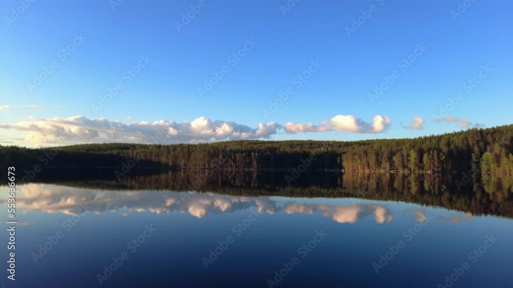 Tranquil lake scenery by sunset golden hour in the wilderness. Pan from right to left. Tranquil lake scenery by sunset golden hour in the wilderness. Pan from right to left.