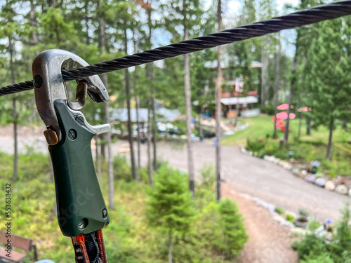 Selective focus on a safety clip used on a high wire ropes course 