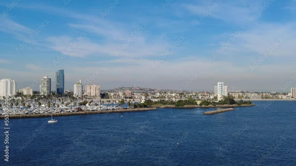 The view of the boat harbor and buildings in the city along Queensway Bay on a sunny day near Long Beach, California, U.S.A - filmed in 4K 60fps The view of the boat harbor and buildings in the city along Queensway Bay on a sunny day near Long Beach, California, U.S.A - filmed in 4K 60fps
