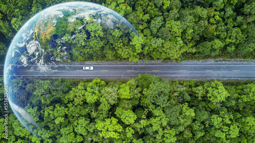 Fotografia, Obraz Electric car and EV electrical energy for environment, EV car on forest road with earth planet going through forest, Ecosystem ecology healthy environment, Electric car with nature, Save earth energy