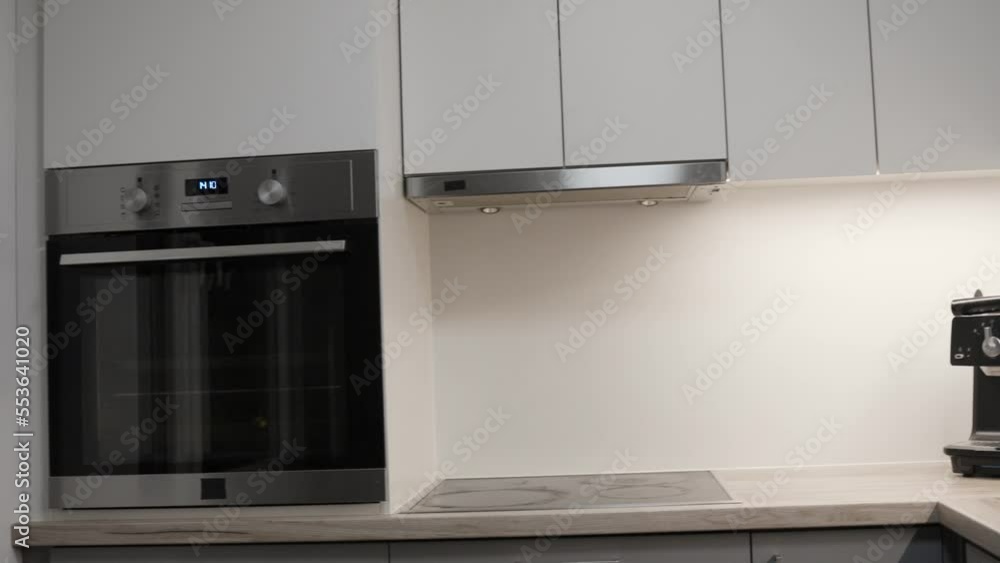 Modern beautiful kitchen interior with oven and cabinets, reveal motion view Modern beautiful kitchen interior with oven and cabinets, reveal motion view