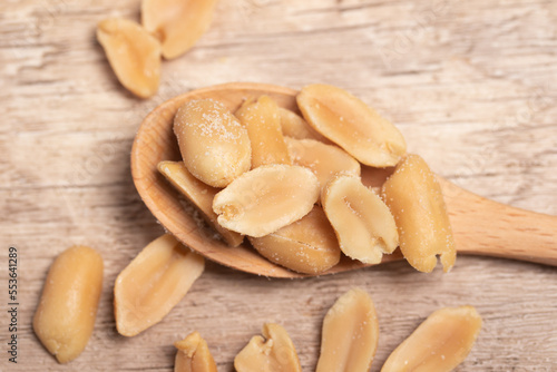 salted roasted peanuts on wooden background