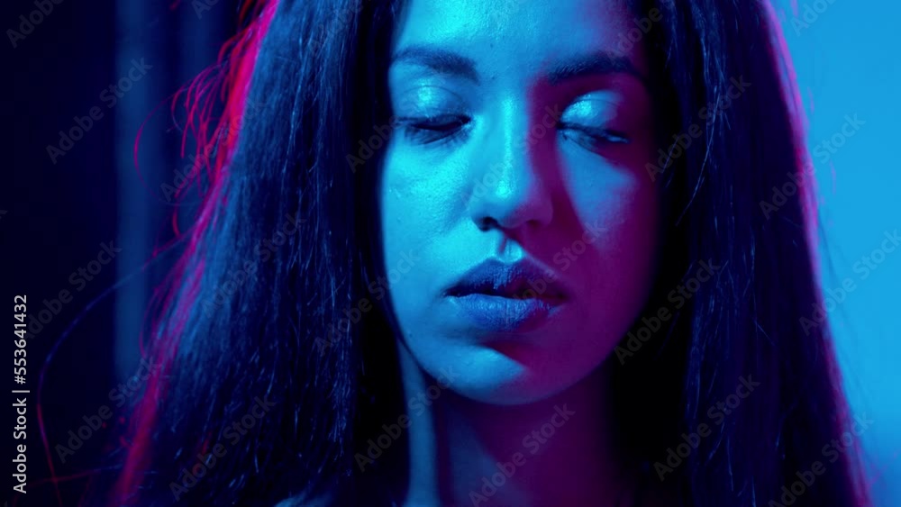 unhappiness, solitude - moroccan woman in the dark stares at camera seriously unhappiness, solitude - moroccan woman in the dark stares at camera seriously