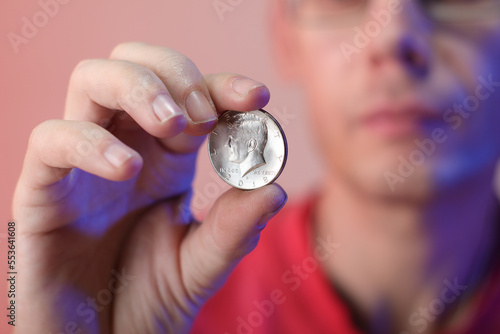 Fototapeta Naklejka Na Ścianę i Meble -  a person holding a coin in his right hand