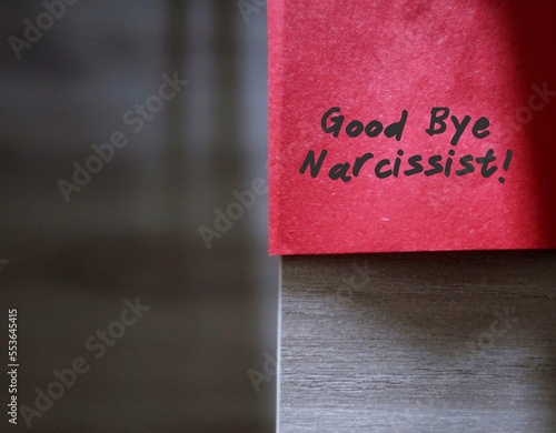 Red sticky note with text written GOOD BYE NARCISSIST, concept of stay away from narcissist who obsess too much in themselves and lack of empathy