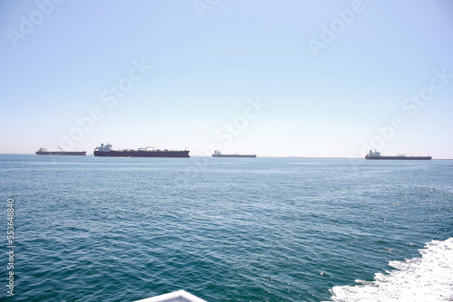 Obraz na plátne A view of several oil tankers parked off the coast.
