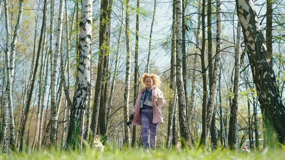 Active Young Woman Running With Her Dog In A Park With Birch Trees. Static, Slow Motion Active Young Woman Running With Her Dog In A Park With Birch Trees. Static, Slow Motion